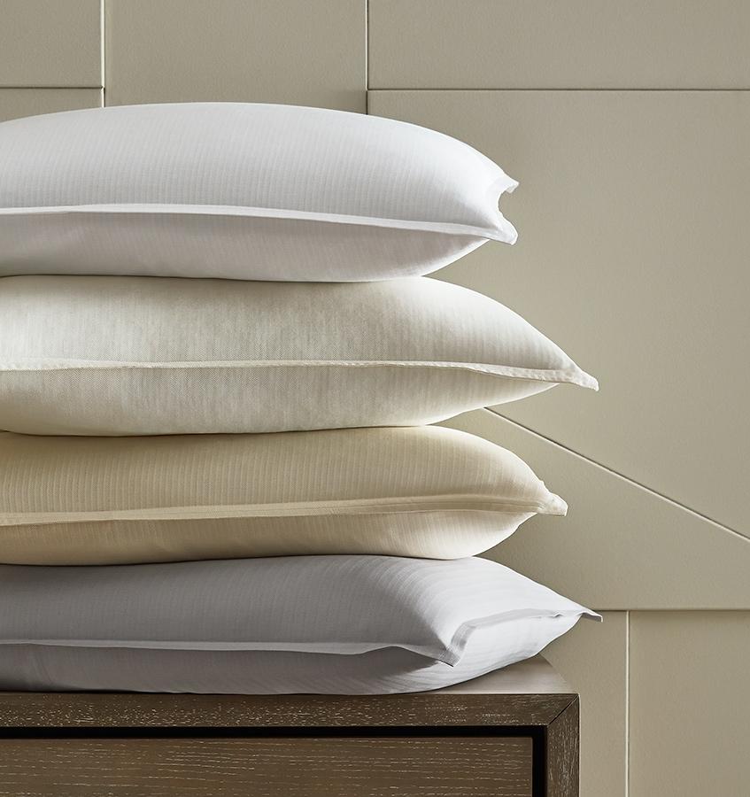 A stack of shams covered with SFERRA Tesoro luxury bedding, crafted from the finest cotton in the world.
