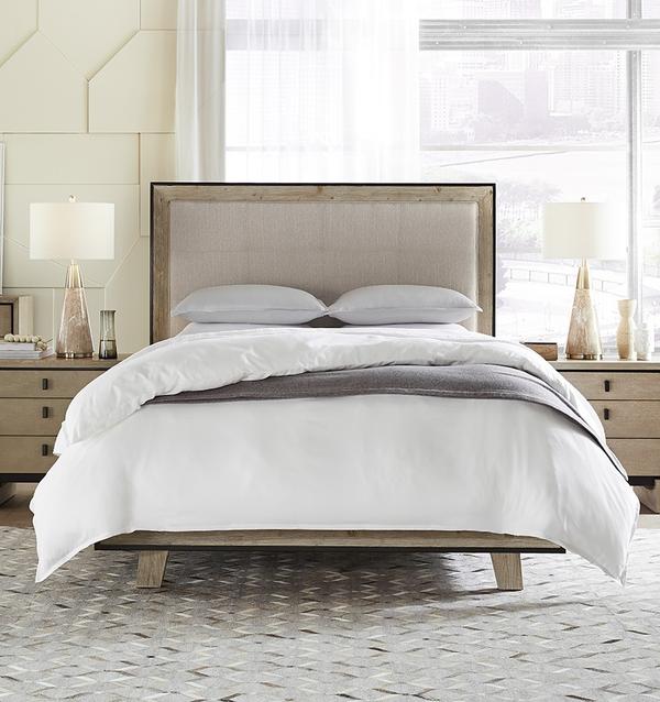 A bed with SFERRA Tesoro luxury bedding, crafted from the finest cotton in the world.
