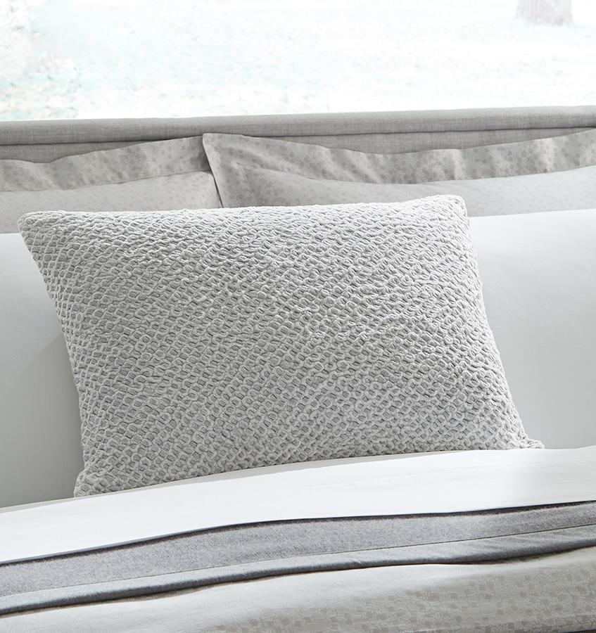 The Zea Decorative Throw Pillow features silver metallic threads interwoven throughout its intensely textured cotton knit.